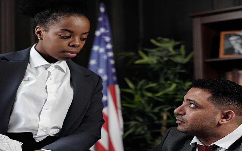 Black Woman government official talking with her co-worker at the office