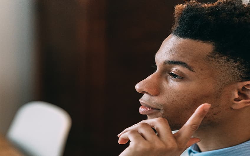 Black Man at the office in a thinking pose