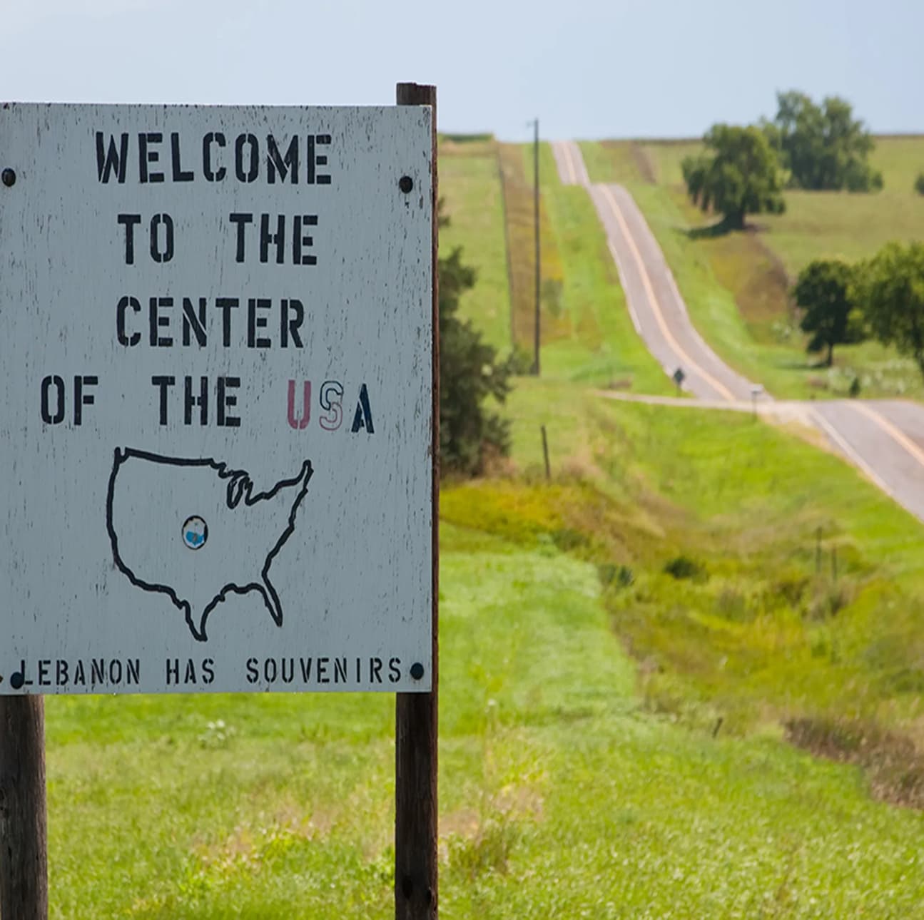 a hilly country road in the summer time of middle america