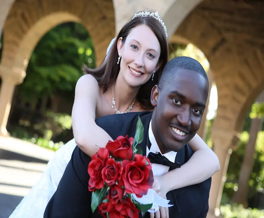 A white woman and Black Man celebrating on their wedding day